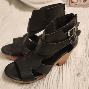 A pair of black thicker heal sandal  about 3 inches high, I would say.